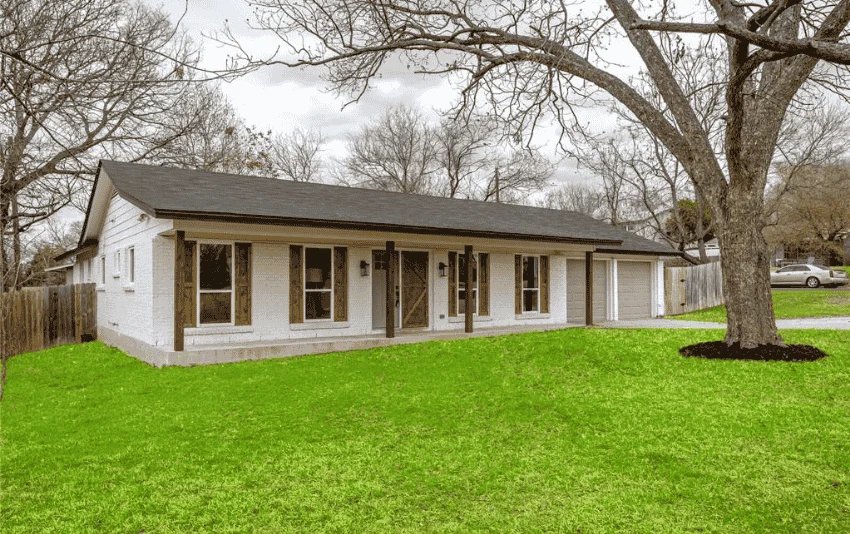 Pale exterior siding on a single-story house with a wide covered porch.
